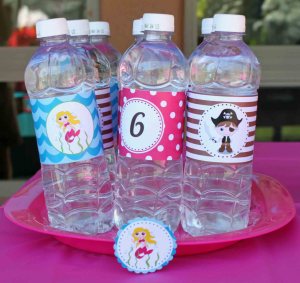 Water bottles adorned with mermaid, pirate, and number six wraps. 